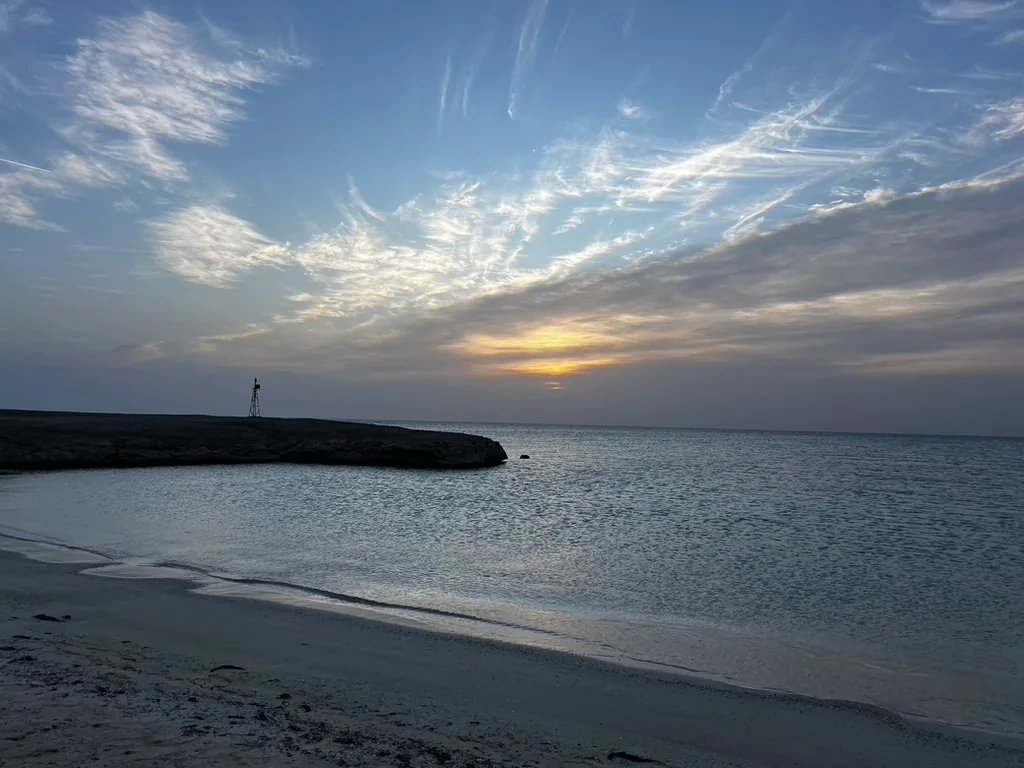 An empty Red Sea beach at sunset