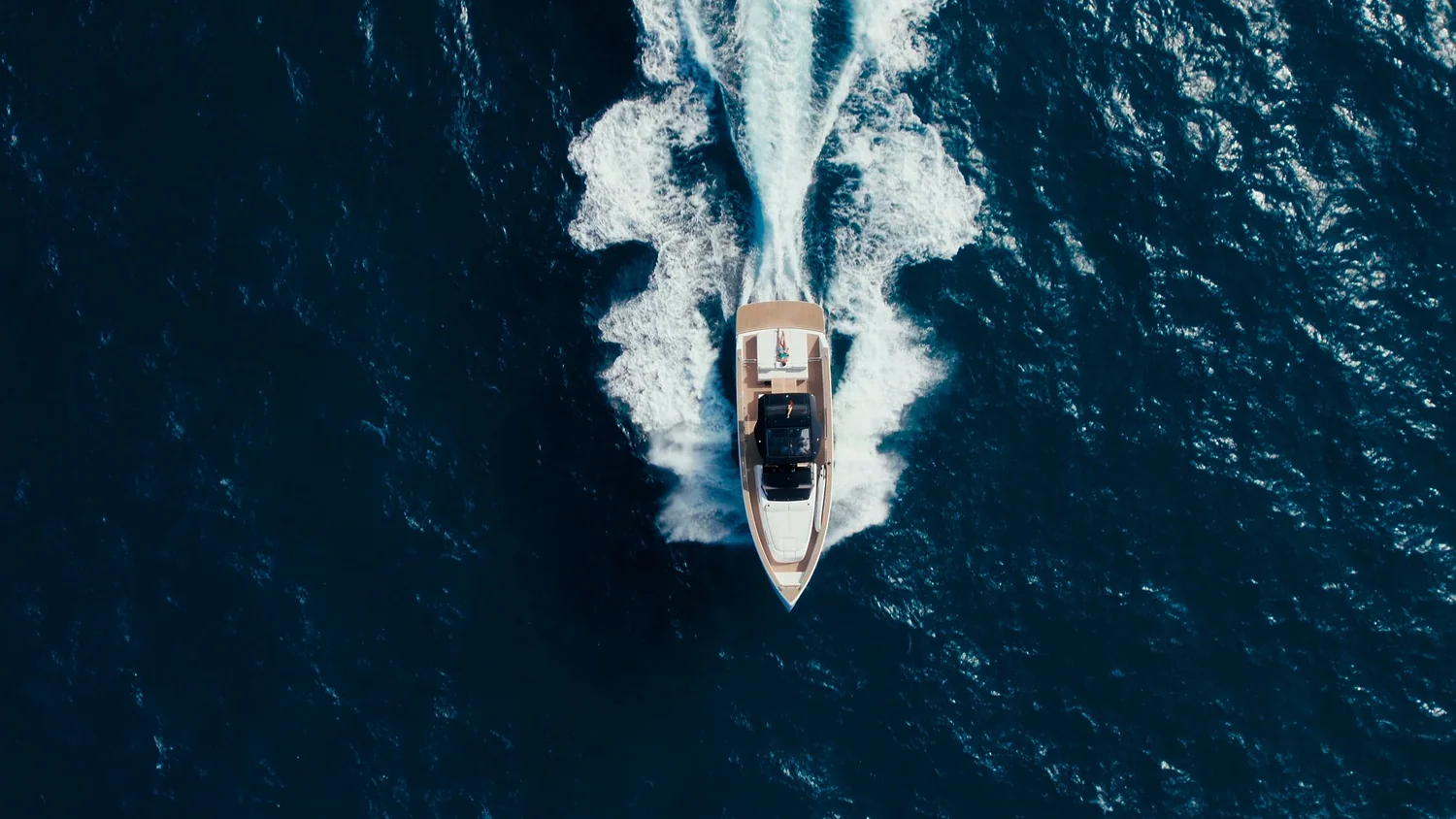 A rigid inflatable boat underway on open blue water