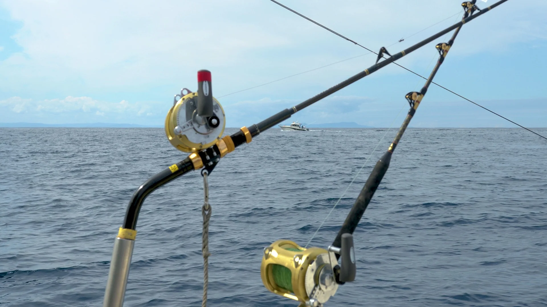 Two conventional reels loaded in rod holders on a boat off the Egyptian coast