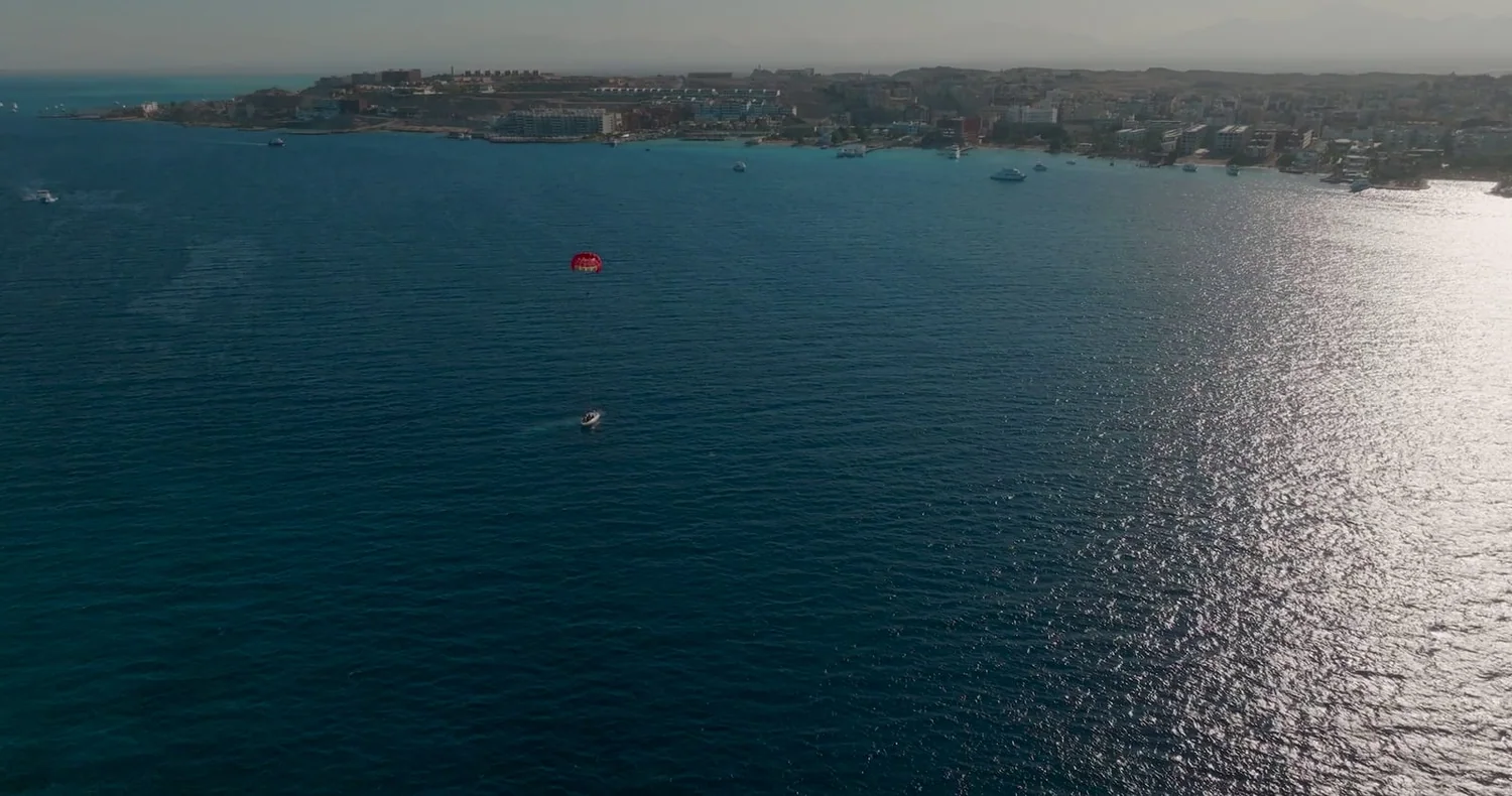 Aerial view of the Hurghada coastline, dive boats and a parasail on the water