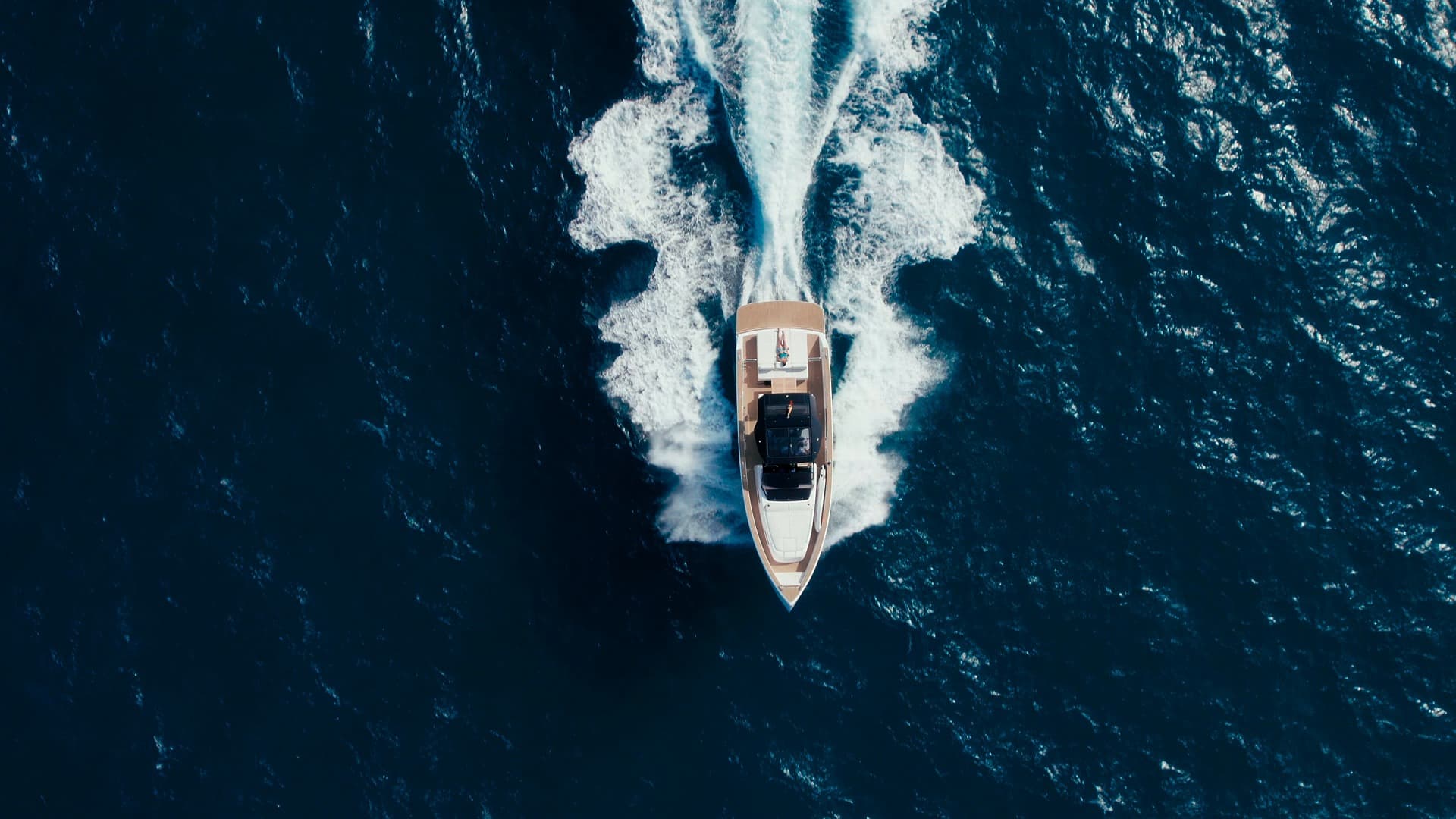 A rigid inflatable boat underway on open blue water