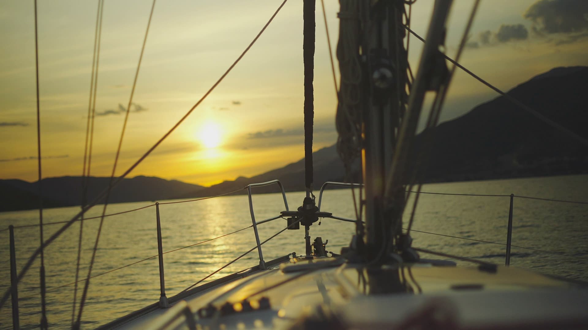 The bow of a boat heading into a Red Sea sunset